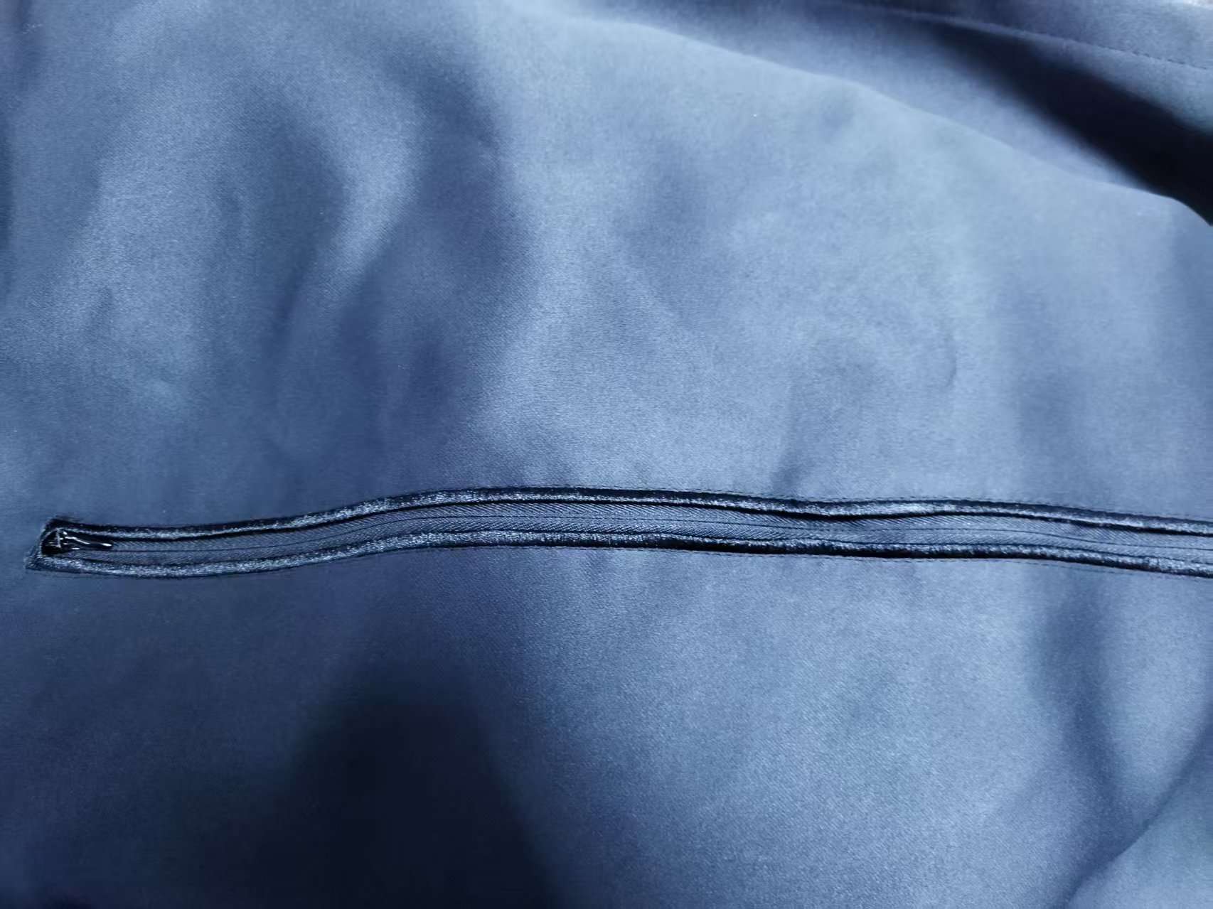 Fabric panel laid flat showing zipper hand access points